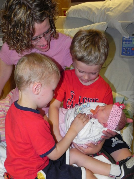 Abby Meyers with newborn girl held by 2 older sibling boys