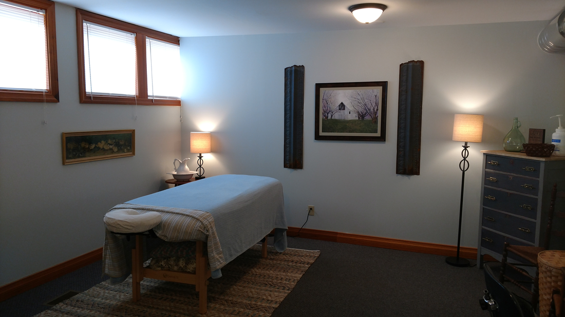 Interior view of Abby Meyers Massage Office, shows massage table and decor